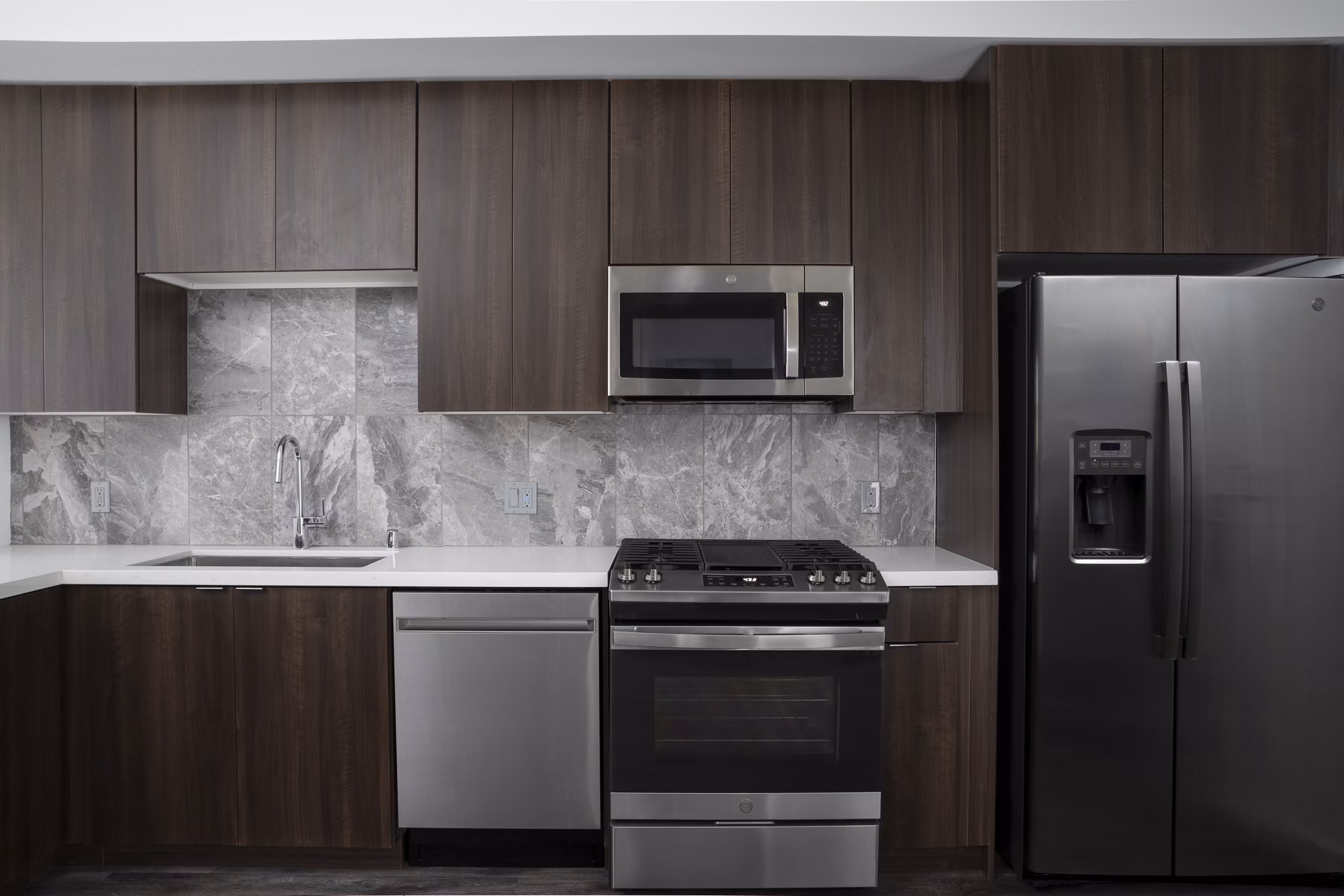 Contemporary kitchen with stainless steel appliances in Vert Apartments