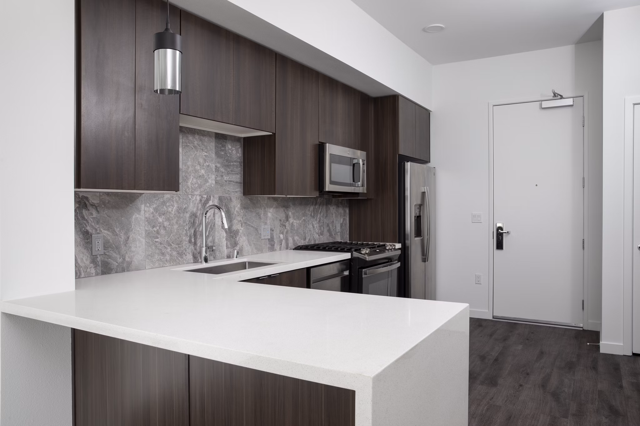 Modern kitchen with stainless steel appliances at Vert Apartments