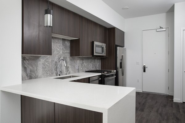 Modern kitchen with stainless steel appliances at Vert Apartments