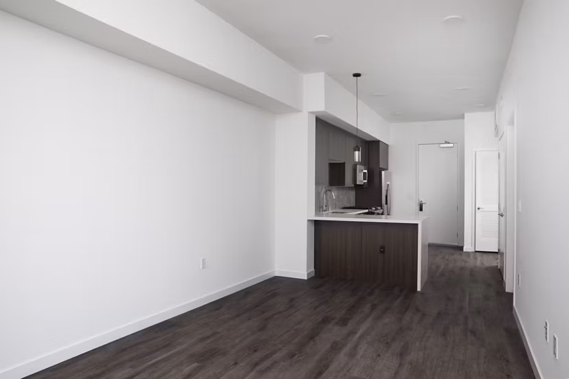 Living room with modern decor and large windows at Vert Apartments, luxury living by Greystar