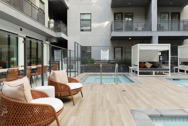 Infinity pool with city skyline views at Vert Apartments