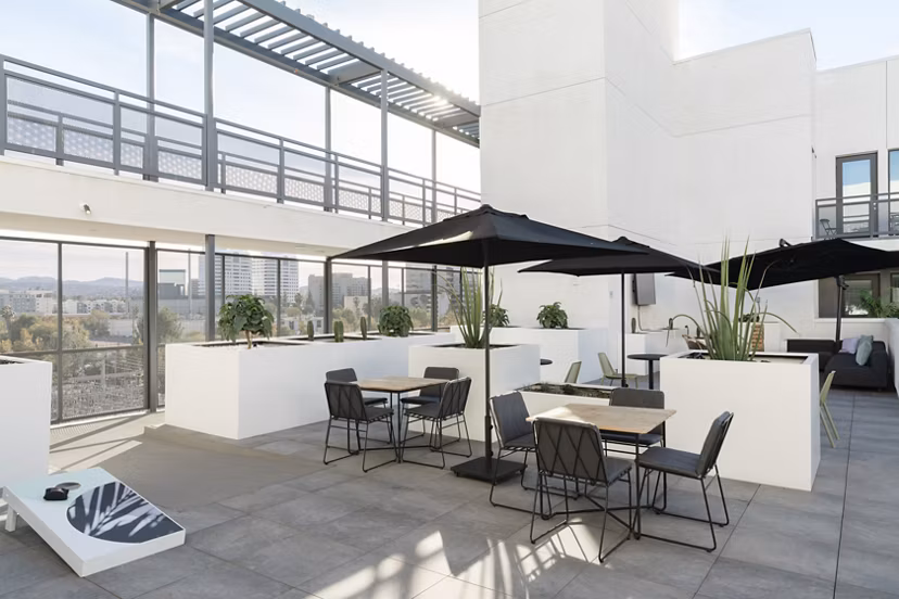 Scenic rooftop deck with cozy seating and lush greenery at Vert Apartments