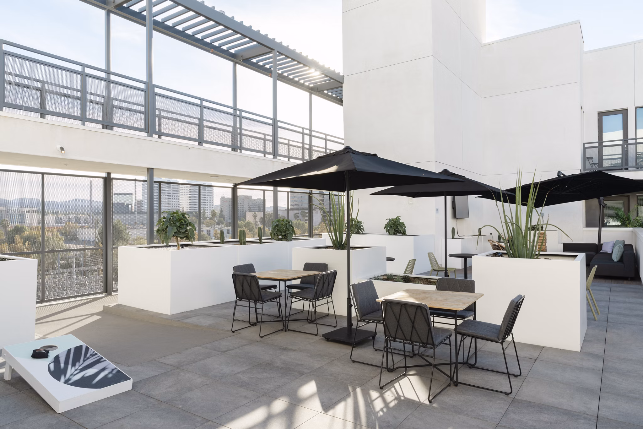Scenic rooftop deck with cozy seating and lush greenery at Vert Apartments