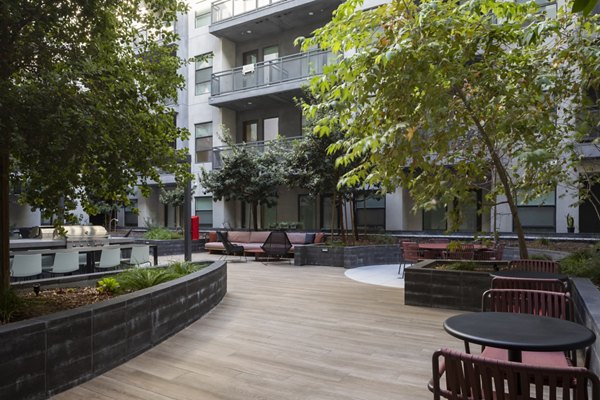 Courtyard at Vert Apartments: Lush greenery and seating area in luxury apartment community