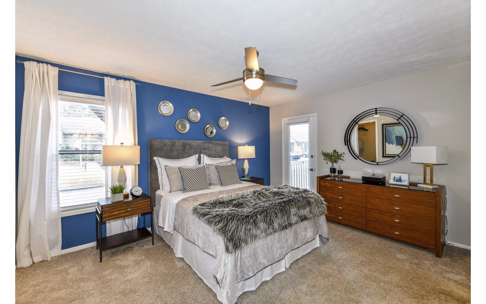 Bedroom with stylish decor and plush bedding in Avana Powers Ferry Apartments, offering comfort and modern luxury living spaces