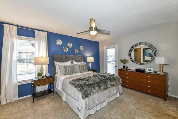 Bedroom with stylish decor and plush bedding in Avana Powers Ferry Apartments, offering comfort and modern luxury living spaces