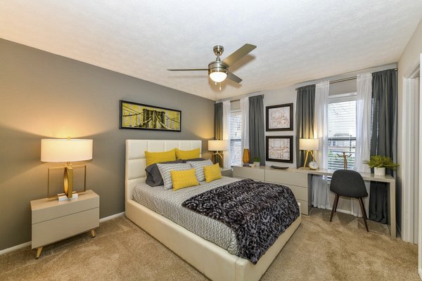 Spacious bedroom with modern decor at Avana Powers Ferry Apartments in Atlanta, featuring large windows and ample natural light