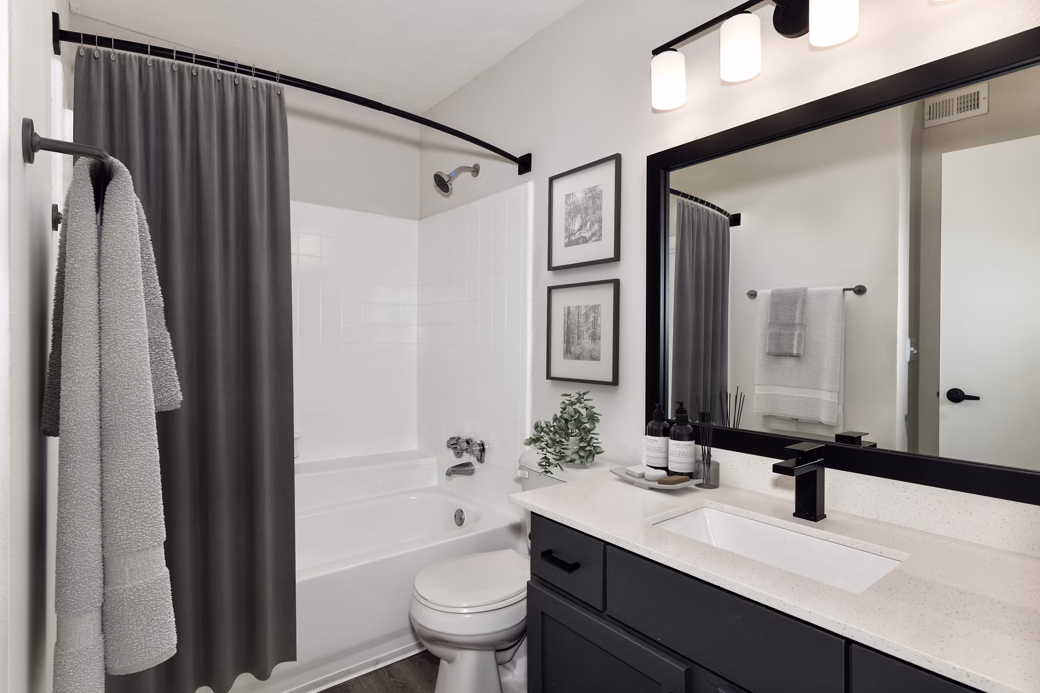 Bathroom with modern fixtures and granite countertops at Avana Powers Ferry Apartments