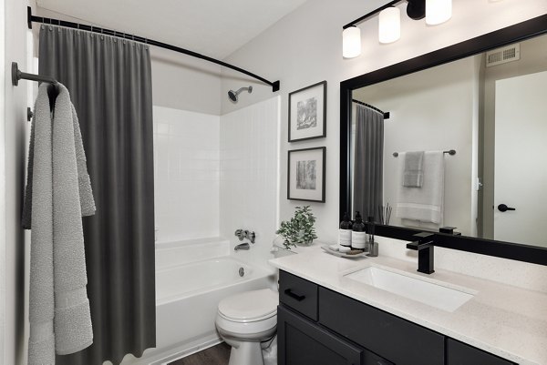 Bathroom with modern fixtures and granite countertops at Avana Powers Ferry Apartments