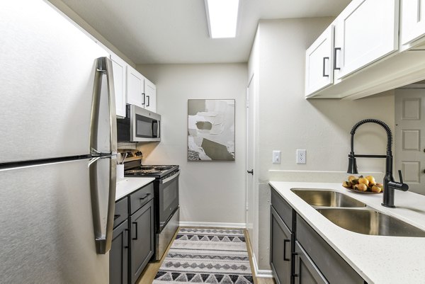 Modern kitchen with stainless steel appliances at Avana Powers Ferry Apartments
