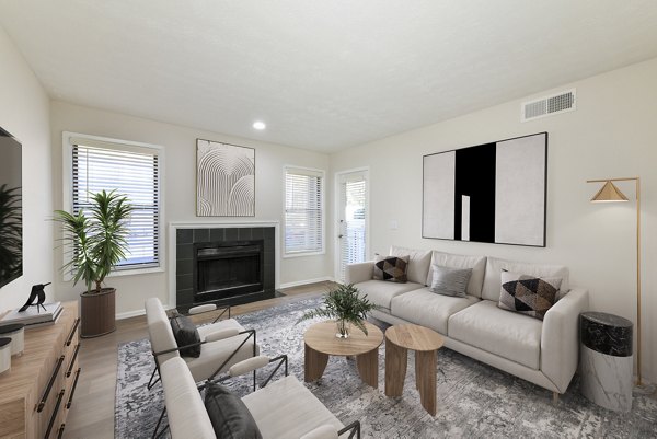 Modern living room with sleek furnishings and natural light at Prado Apartments