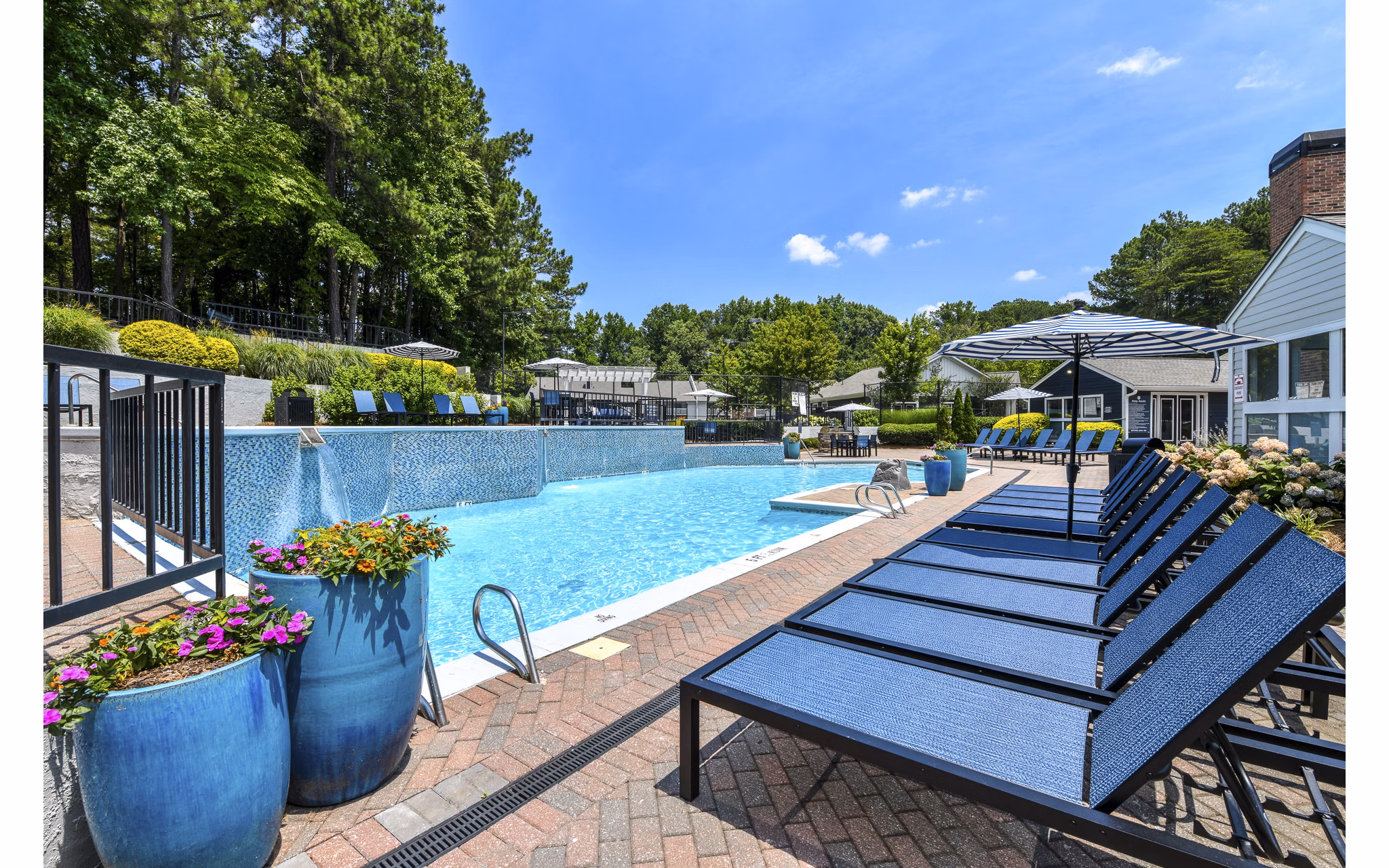 Relaxing outdoor pool with lounge chairs at Avana Powers Ferry Apartments, offering a luxurious amenity for residents