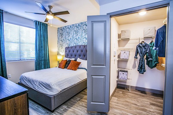 Spacious bedroom with modern decor in The Alcove Apartments featuring Greystar luxury apartment design
