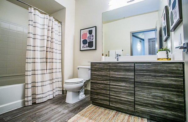 Luxurious bathroom with modern fixtures at The Alcove Apartments, showcasing sleek design and elegant finishes