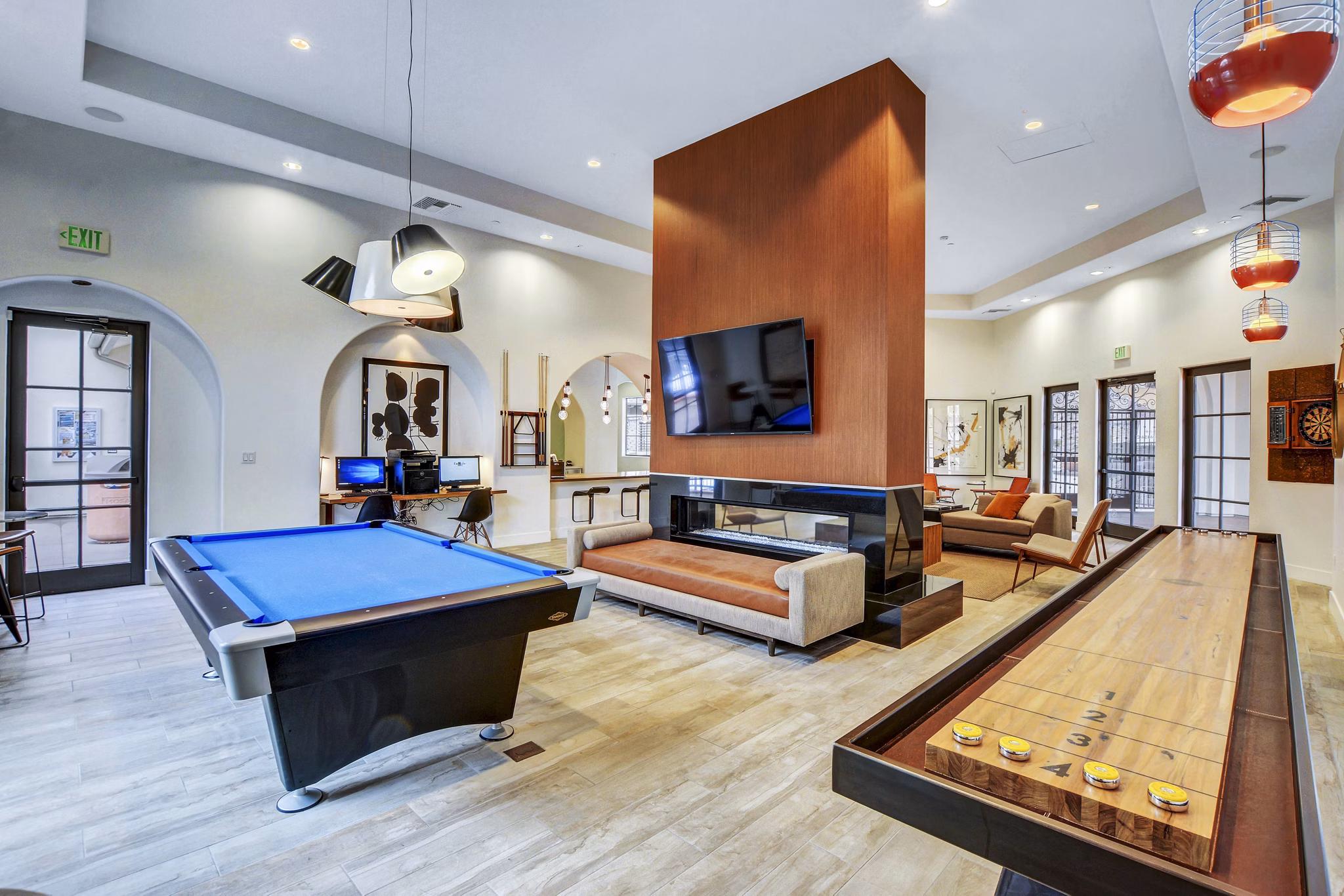 Clubhouse game room with modern decor and pool table at The Alcove luxury apartments