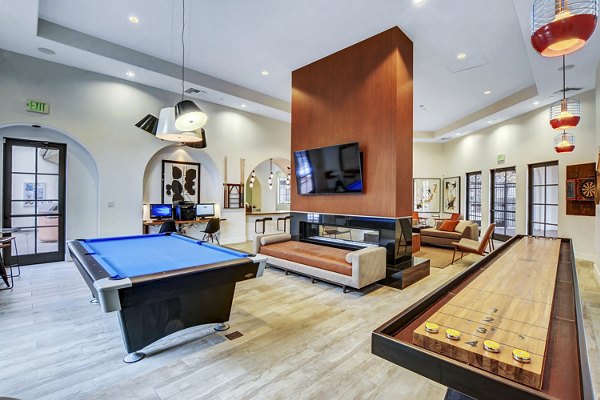 Clubhouse game room with modern decor and pool table at The Alcove luxury apartments