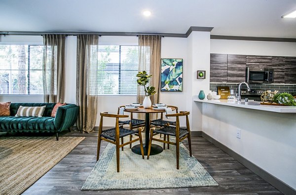 Dining room with elegant decor and modern furnishings at The Alcove Apartments, luxury living by Greystar in a premium location