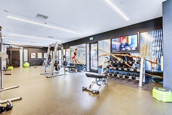 Fitness center with modern equipment at The Alcove Apartments, offering residents a premium workout experience