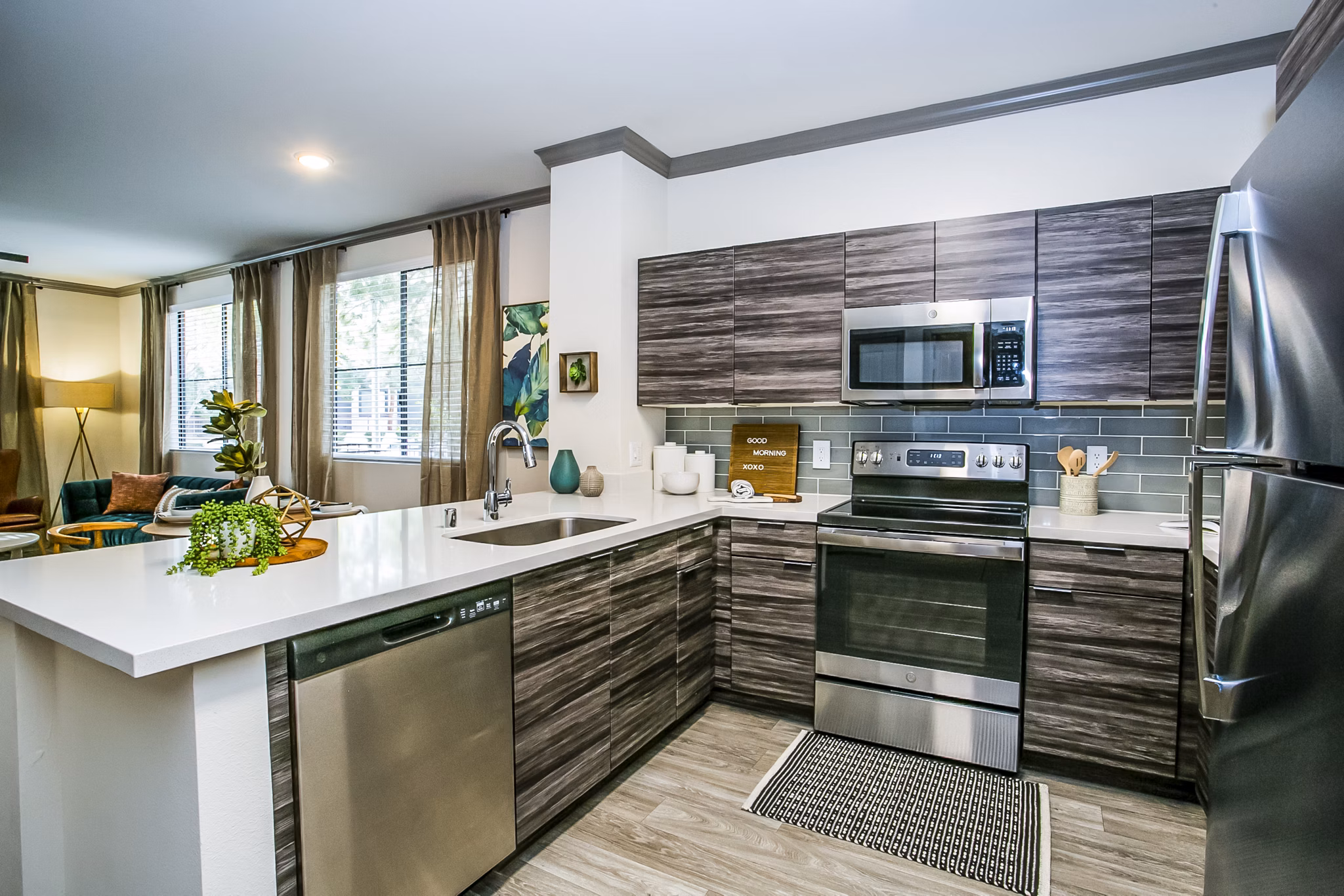 Modern kitchen with sleek countertops and stainless steel appliances at The Alcove Apartments, a luxury property by Greystar