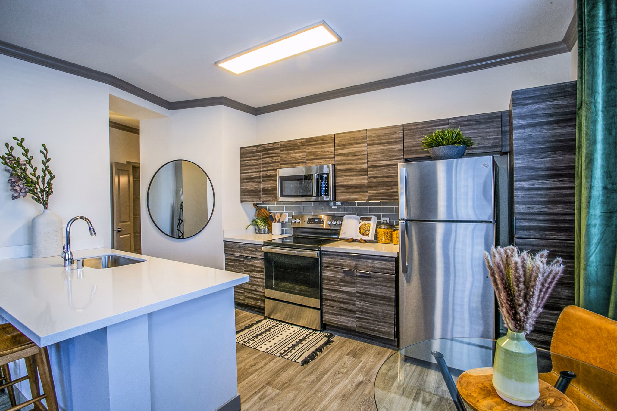 Modern kitchen with stainless steel appliances at The Alcove Apartments, a Greystar luxury living community