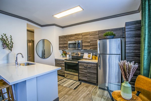 Modern kitchen with stainless steel appliances at The Alcove Apartments, a Greystar luxury living community