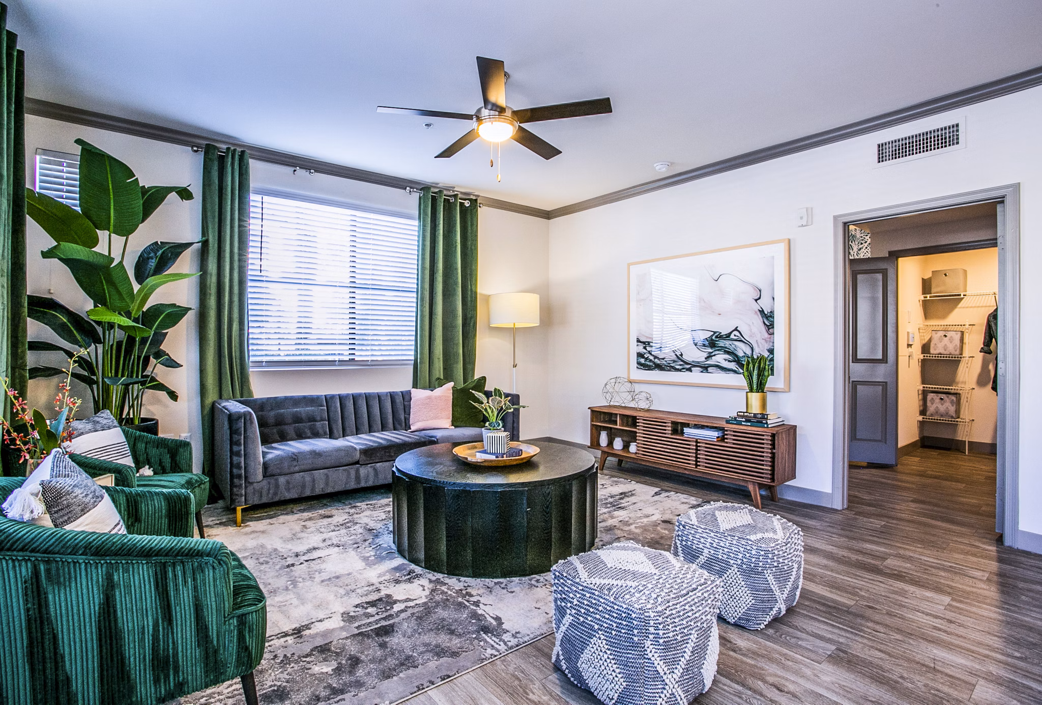 Spacious living room with modern decor and large windows in The Alcove Apartments, a luxury property by Greystar