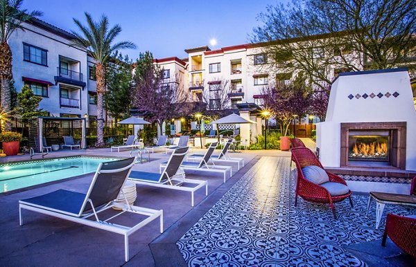 Fire pit beside luxury pool area at The Alcove Apartments, perfect for evening relaxation