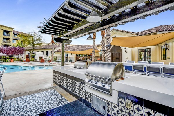 Grill area with modern patio at The Alcove Apartments offering luxury outdoor living