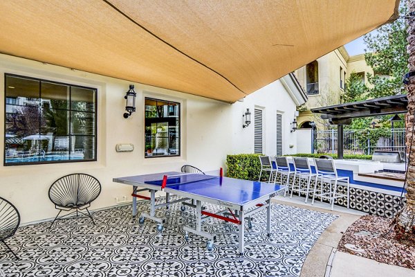 The Alcove Apartments: Modern patio and recreation area featuring stylish seating and lush greenery