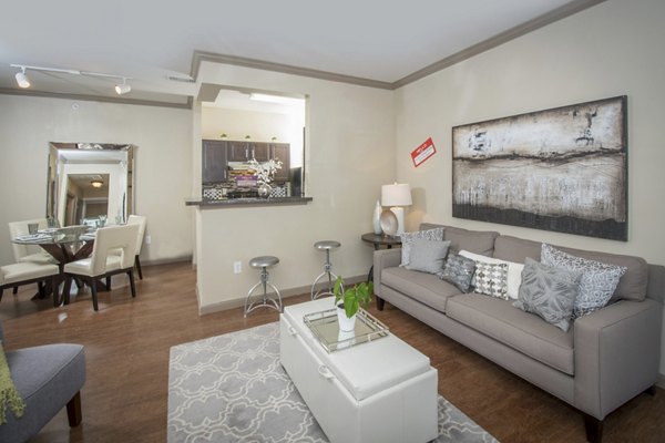 Stylish living room with modern furnishings and ample natural light at The Highline Apartments