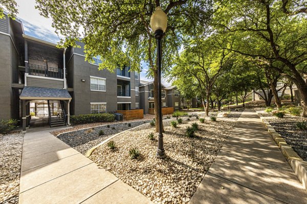 Courtyard with modern landscaping and seating at The Highline Apartments, a luxury community in an urban environment