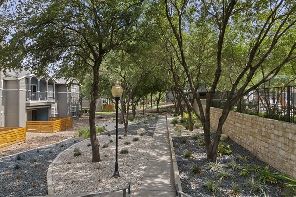 Courtyard with lush greenery and modern seating at The Highline Apartments, a Greystar luxury apartment community