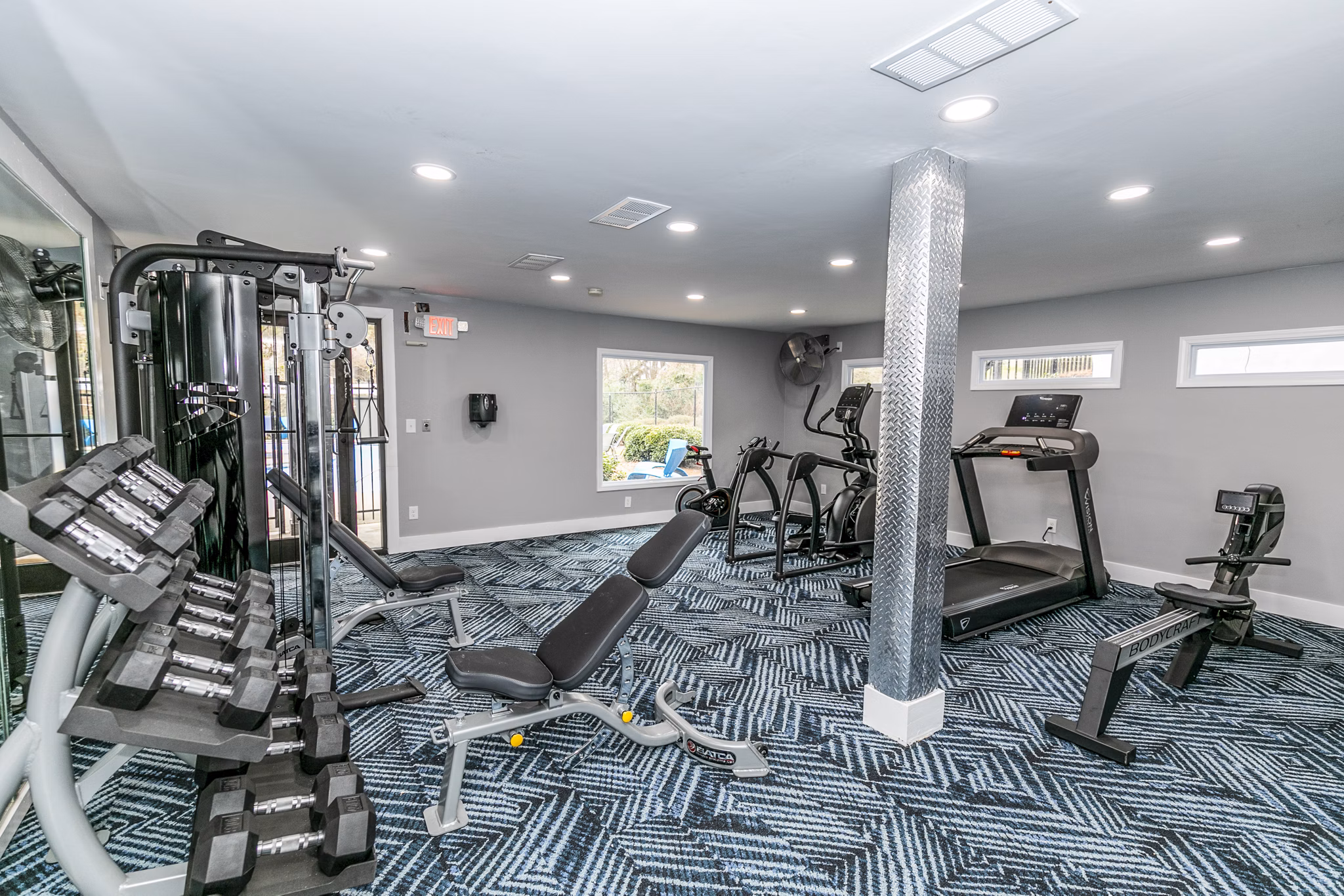 Modern fitness center equipped with state-of-the-art machines at Champions Glen Apartments