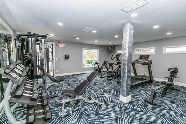 Modern fitness center equipped with state-of-the-art machines at Champions Glen Apartments
