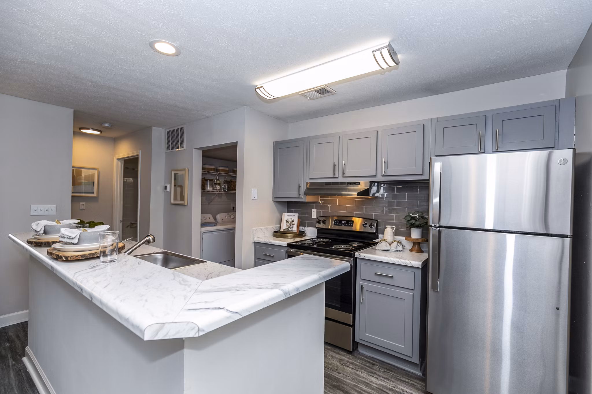 Modern kitchen with sleek countertops and stainless steel appliances in Champions Glen Apartments