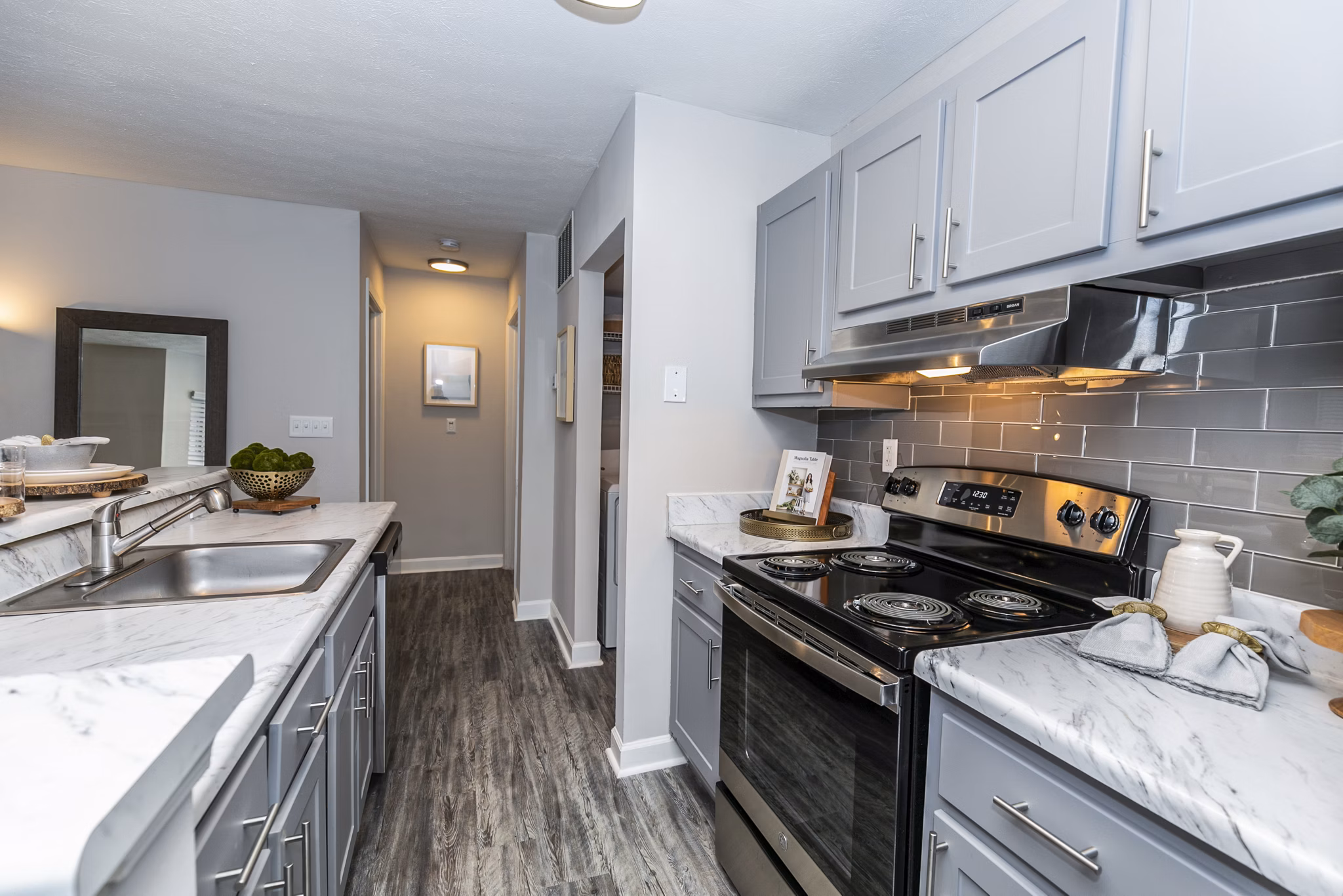 Modern kitchen with stainless steel appliances in Champions Glen Apartments