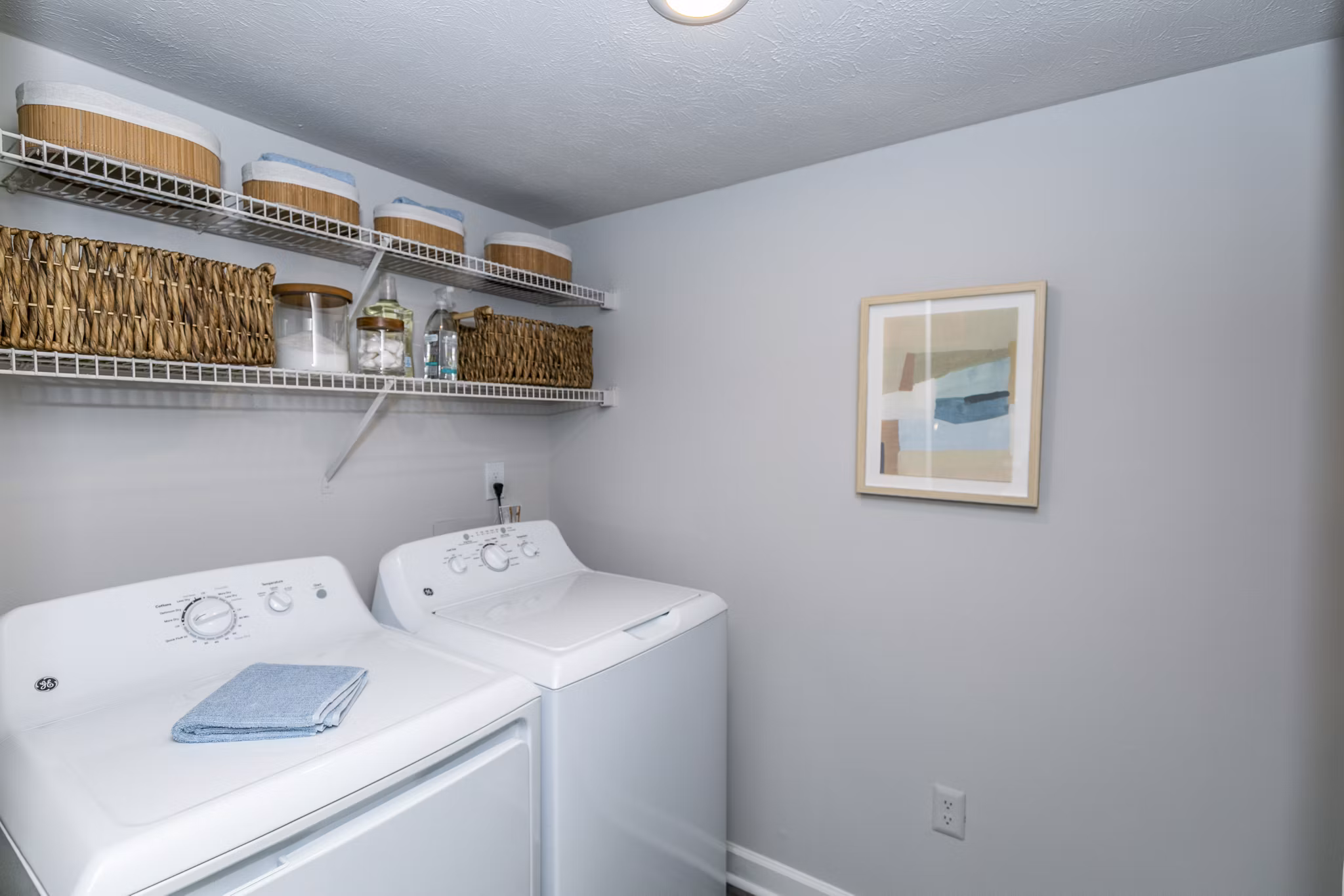 Laundry room with modern appliances at Champions Glen Apartments, offering convenience and efficiency for residents Perfect for daily chores