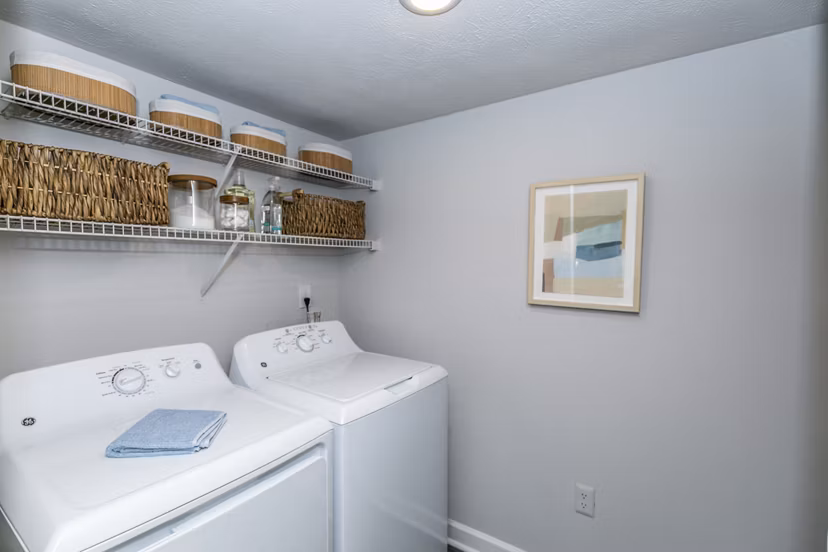 Laundry room with modern appliances at Champions Glen Apartments, offering convenience and efficiency for residents Perfect for daily chores