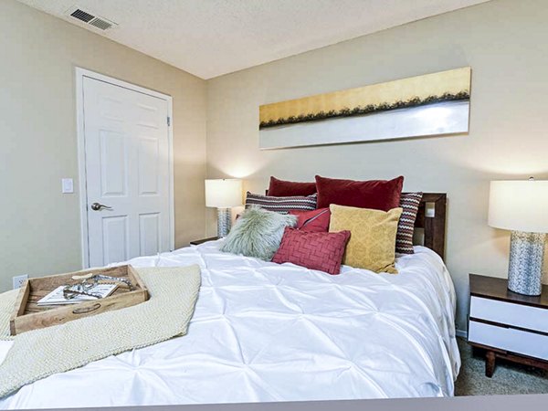 Cozy bedroom with stylish decor at Vineyard Gardens Apartments, luxury property with modern amenities and serene surroundings
