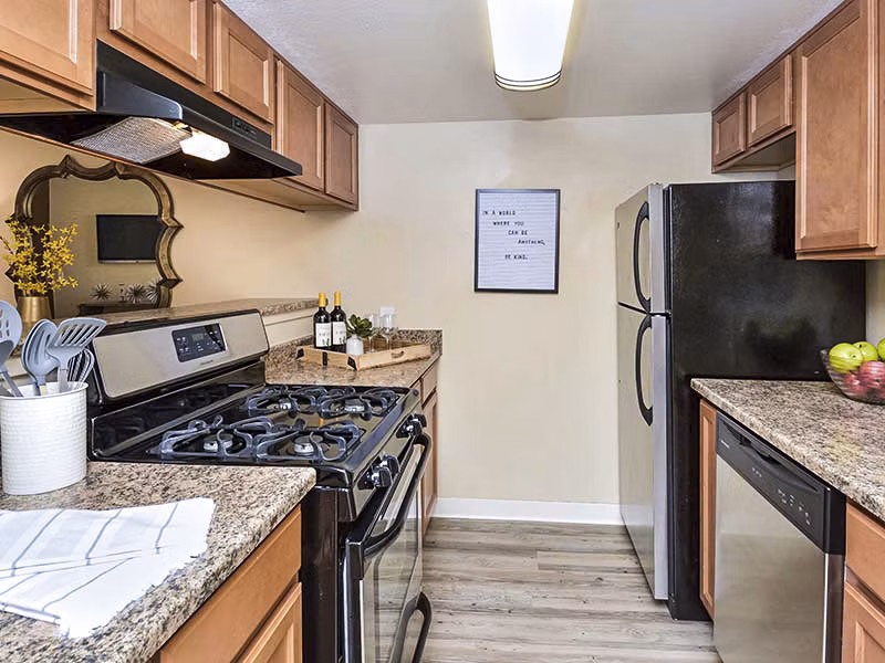 Modern kitchen with stainless steel appliances at Vineyard Gardens Apartments
