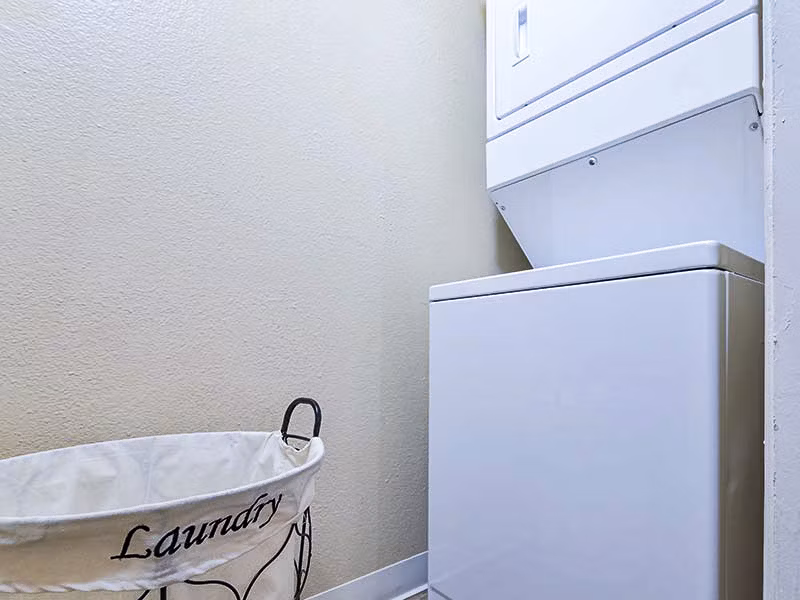 Laundry room with modern appliances at Vineyard Gardens Apartments