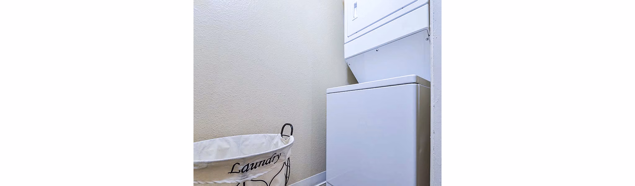 Laundry room with modern appliances at Vineyard Gardens Apartments
