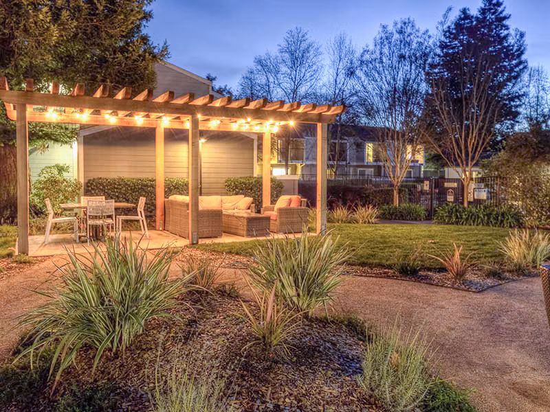 Vineyard Gardens Apartments: Outdoor patio with comfortable seating and lush greenery