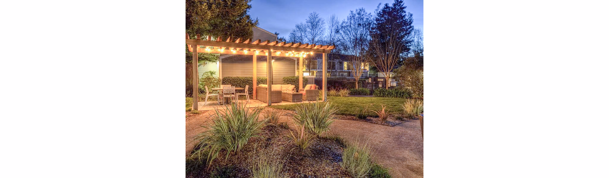 Vineyard Gardens Apartments: Outdoor patio with comfortable seating and lush greenery