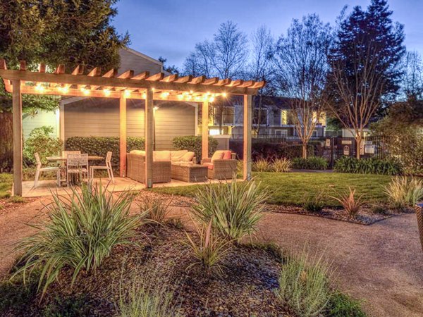 Vineyard Gardens Apartments: Outdoor patio with comfortable seating and lush greenery