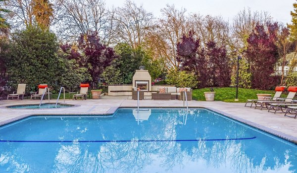 Resort-style pool with lounge chairs at Vineyard Gardens Apartments, offering luxury living and relaxation amenities