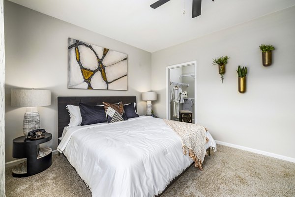 Cozy bedroom with modern decor and natural light at River Oaks Landing Apartments