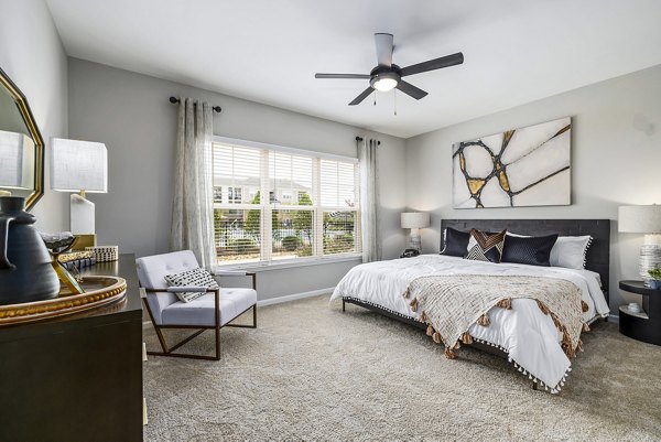 Bedroom interior with plush bedding and stylish decor at River Oaks Landing Apartments Perfect for luxury living in a prime location with Greystar quality