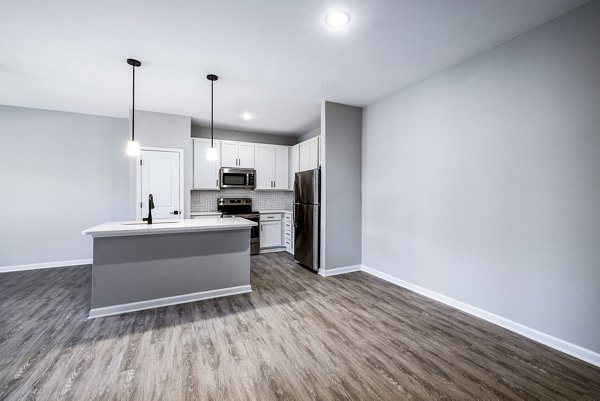 Dining room featuring elegant lighting and modern furnishings in River Oaks Landing Apartments