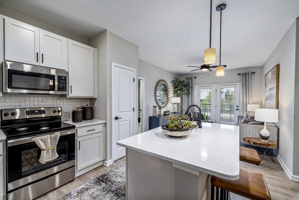 Modern kitchen with stainless steel appliances at River Oaks Landing Apartments